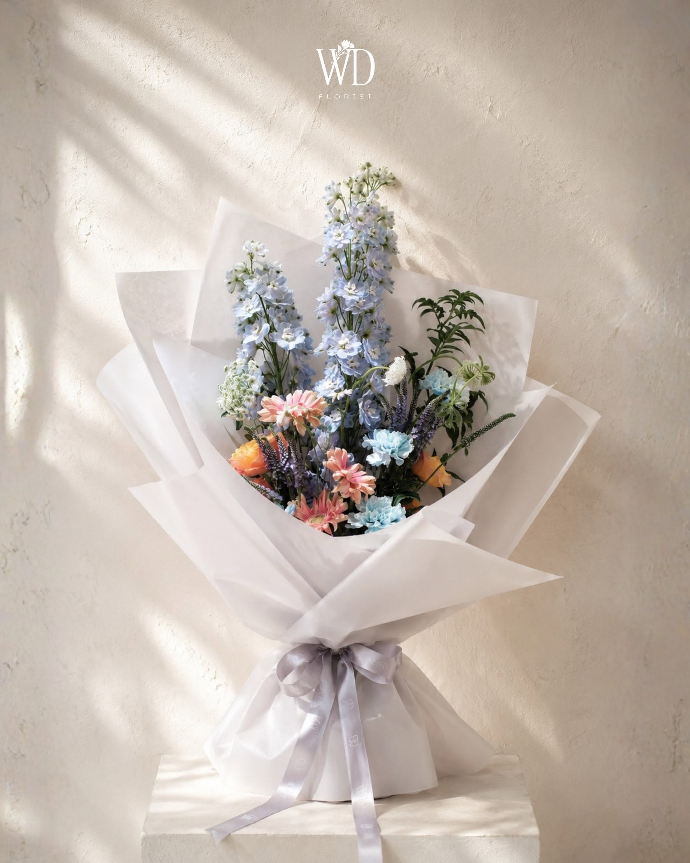 Seasonal corporate flower design for branded spaces